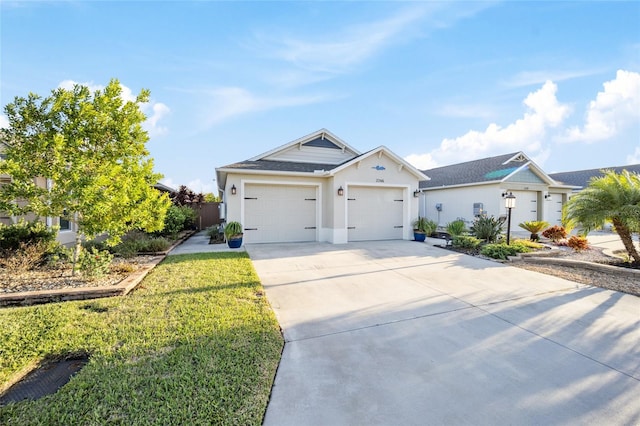 view of front of house featuring a garage and a front lawn