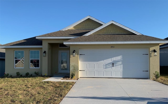 view of front of home with a garage and a front yard