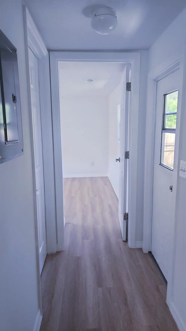 hall with electric panel and hardwood / wood-style flooring