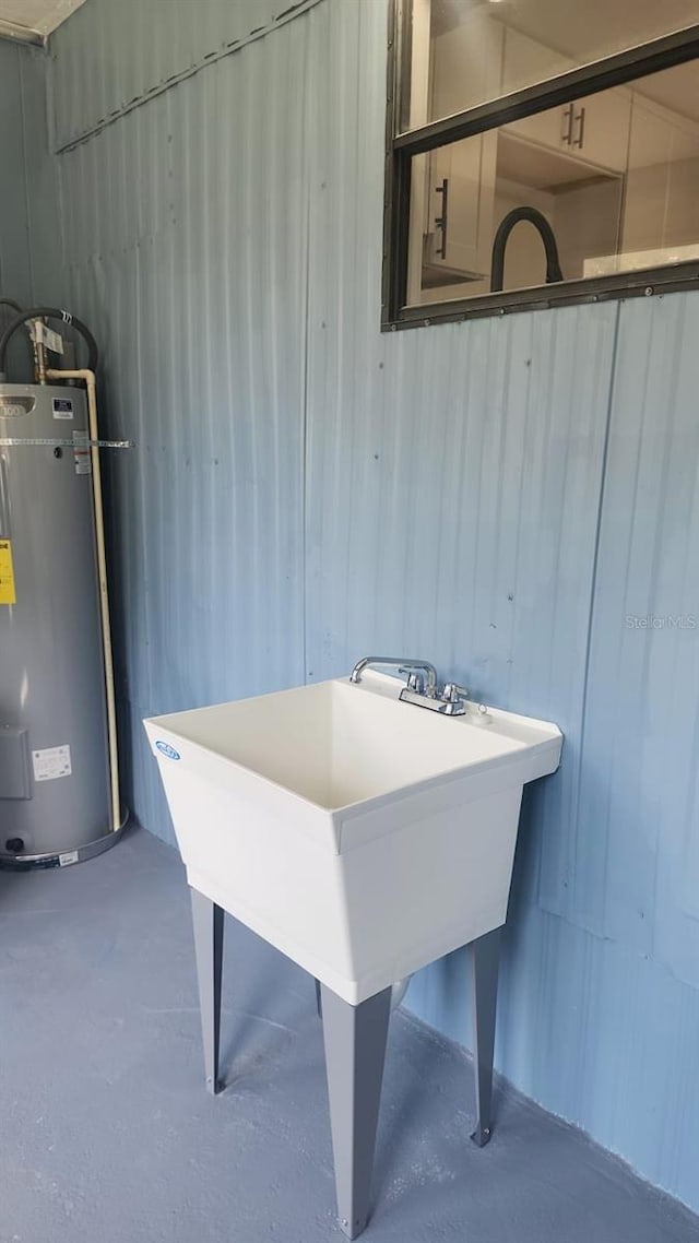 interior space with electric water heater and sink