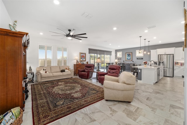 living room with ceiling fan and sink