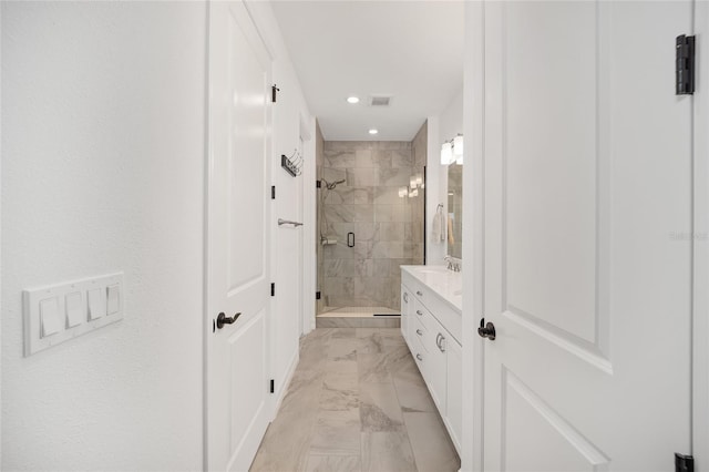 bathroom with vanity and a shower with shower door