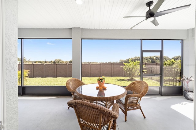 sunroom featuring ceiling fan and a healthy amount of sunlight