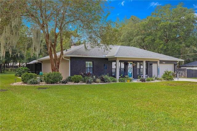 view of front of home with a garage and a front lawn