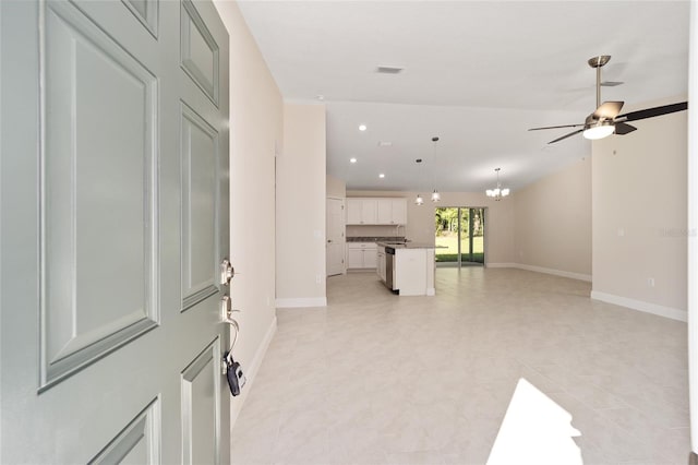 unfurnished living room with sink and ceiling fan with notable chandelier