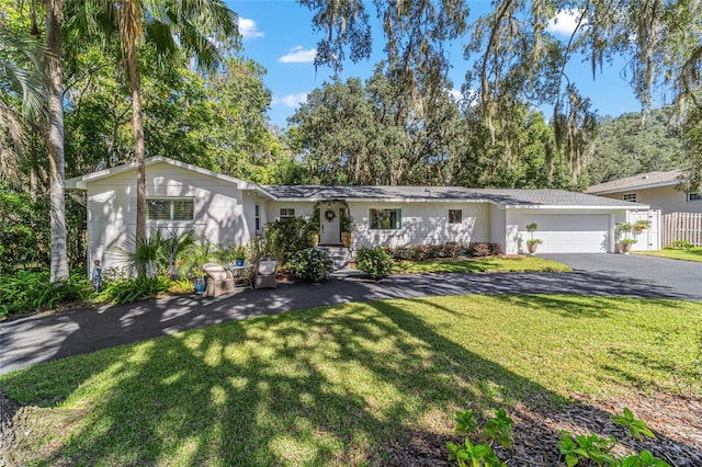 view of front of house with a front lawn and a garage