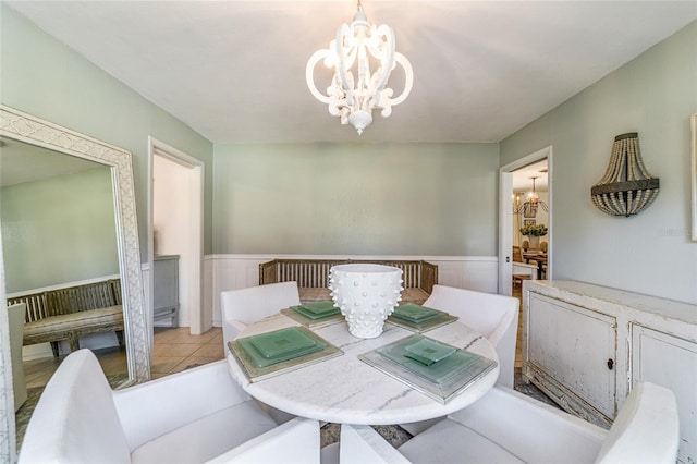 dining area featuring an inviting chandelier and light tile patterned floors