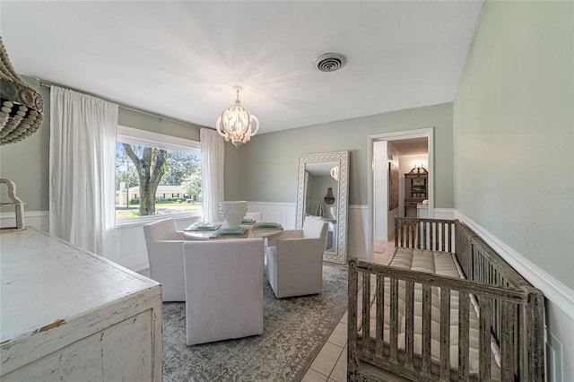 dining space with a chandelier and light tile patterned floors