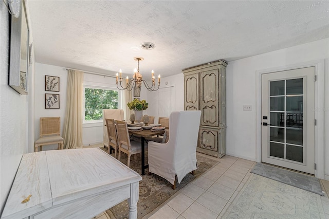 dining room with a chandelier and a textured ceiling