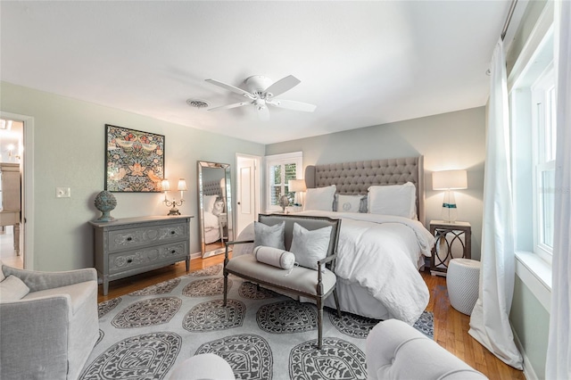 bedroom with light hardwood / wood-style flooring and ceiling fan