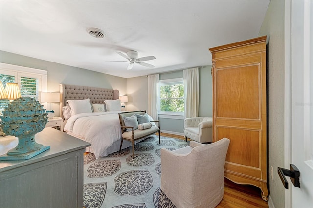 bedroom with light hardwood / wood-style flooring and ceiling fan