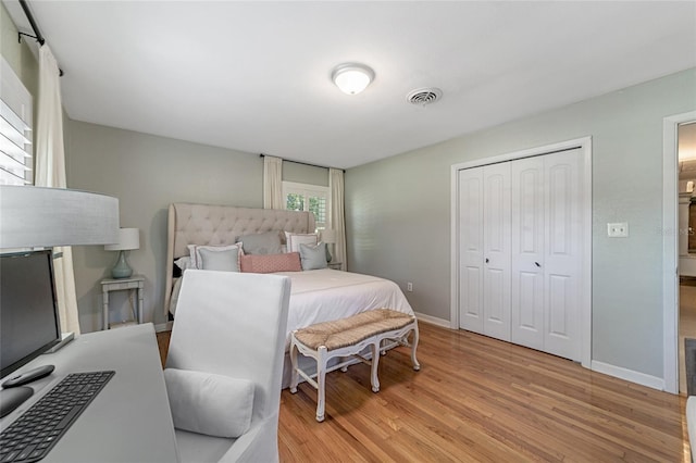 bedroom featuring a closet and light wood-type flooring