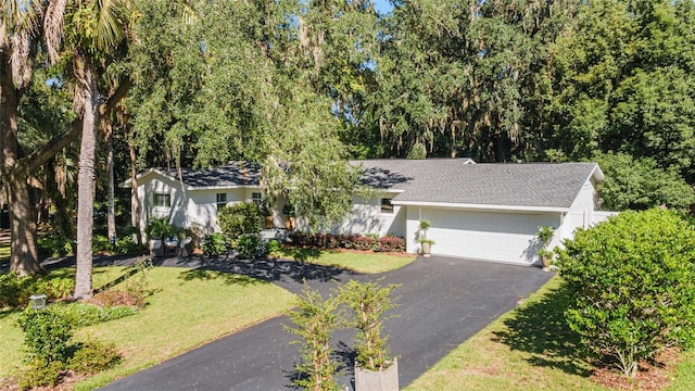 ranch-style home with a front lawn and a garage