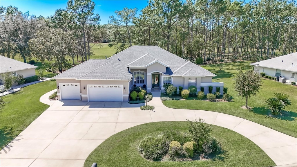 view of front of home featuring a garage and a front lawn