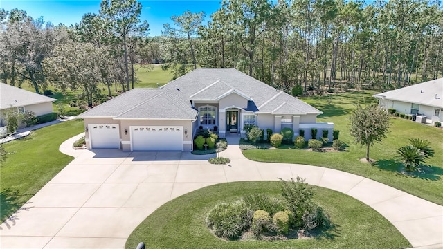 view of front of home featuring a garage and a front lawn