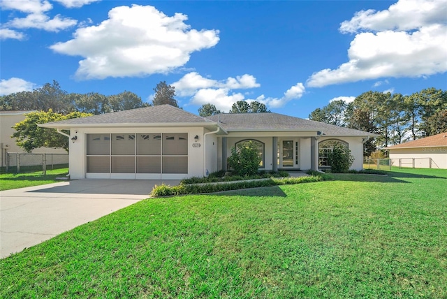 ranch-style home featuring a front yard and a garage