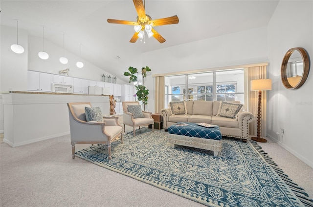 carpeted living room featuring high vaulted ceiling and ceiling fan