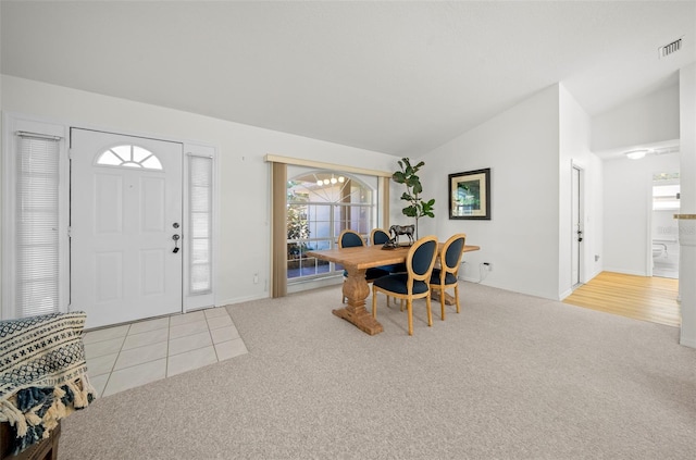 carpeted entryway with lofted ceiling