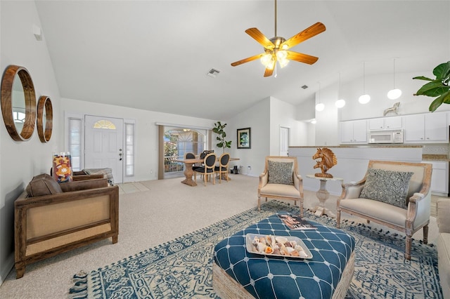 living room featuring vaulted ceiling, light carpet, and ceiling fan