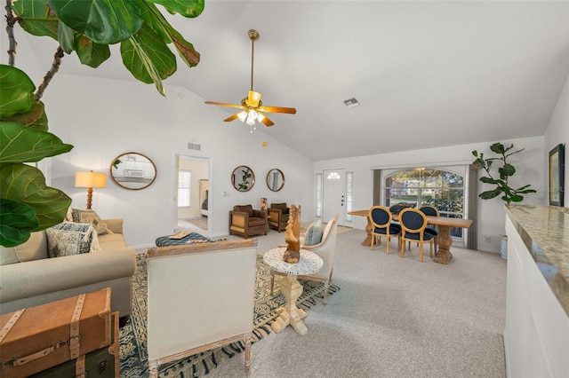 living room with ceiling fan, carpet, and vaulted ceiling