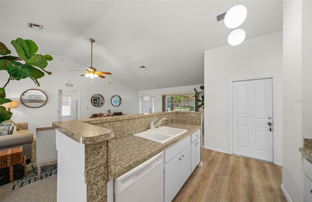 kitchen featuring white dishwasher, sink, vaulted ceiling, light wood-type flooring, and white cabinetry