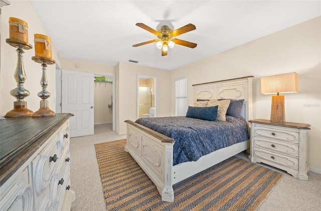 carpeted bedroom featuring ensuite bathroom and ceiling fan