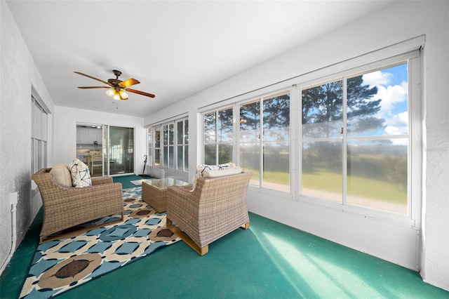 sunroom featuring ceiling fan