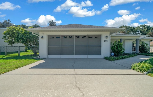 view of front of home with a front lawn and a garage