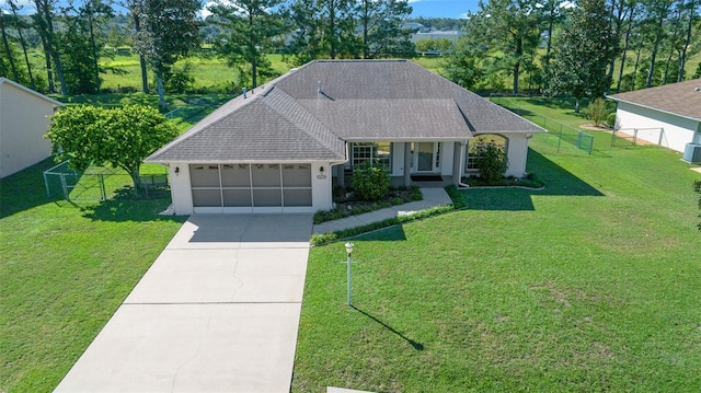 view of front facade with covered porch, a garage, and a front lawn