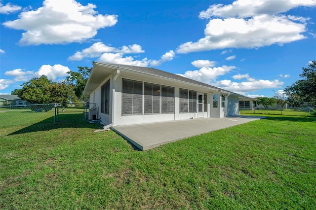 back of property featuring a yard and a patio area