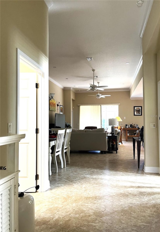 living room featuring ornamental molding, a textured ceiling, and ceiling fan