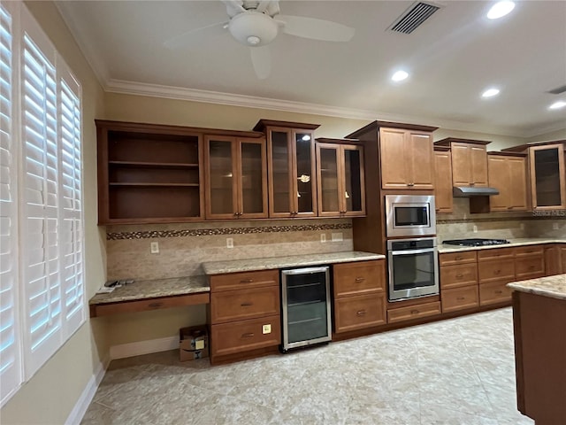 kitchen featuring tasteful backsplash, beverage cooler, ceiling fan, crown molding, and stainless steel appliances