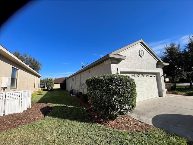 view of property exterior with central AC, a lawn, and a garage