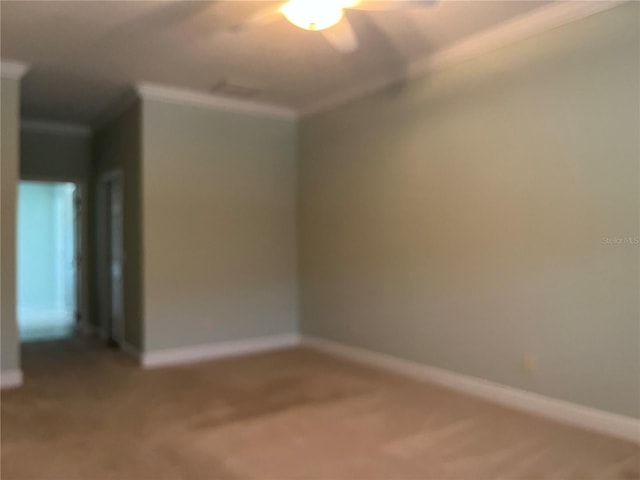 carpeted spare room with crown molding and ceiling fan