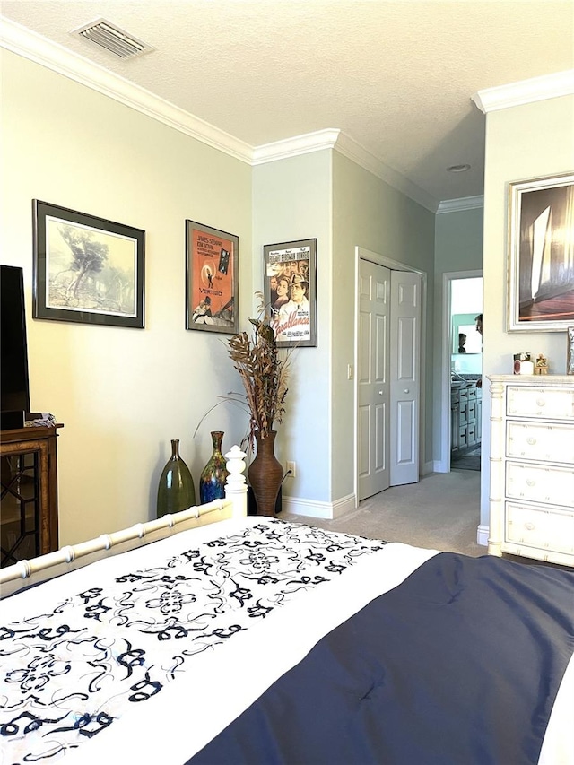 carpeted bedroom featuring a closet, crown molding, and a textured ceiling