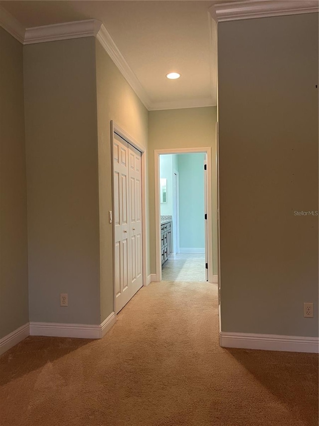 hall with light carpet and crown molding