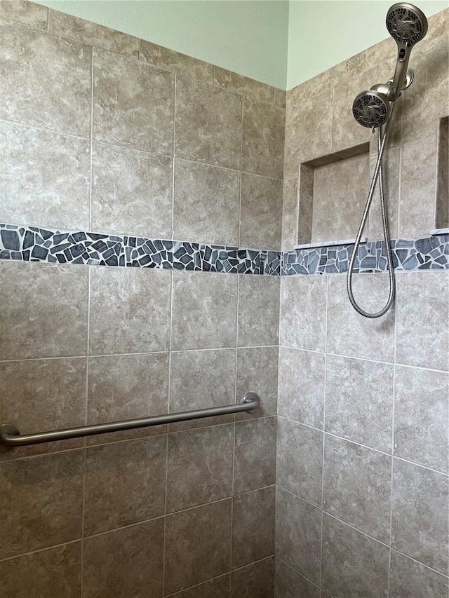 bathroom with a tile shower