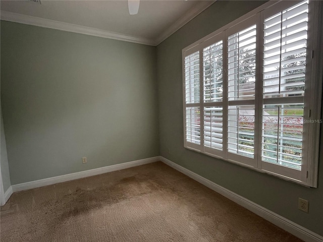 carpeted empty room featuring crown molding and plenty of natural light