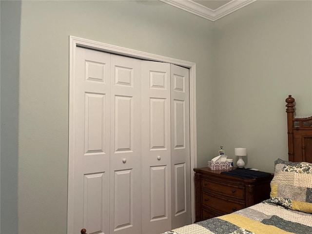 bedroom with a closet and crown molding