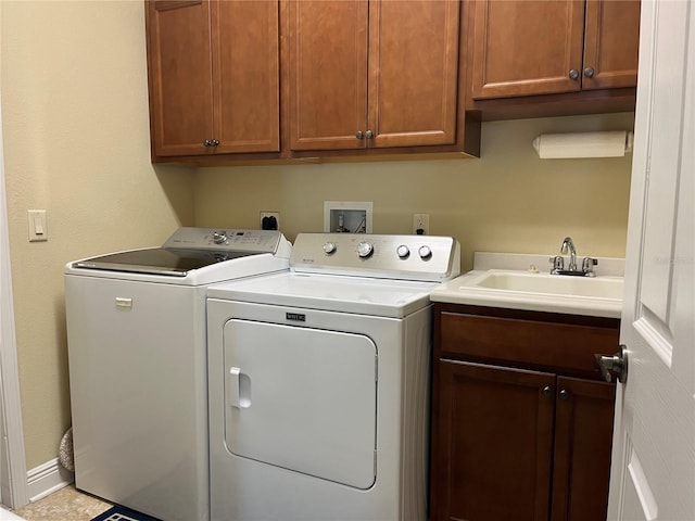 laundry area with sink, washer and clothes dryer, and cabinets