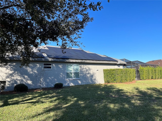 view of side of home with a yard