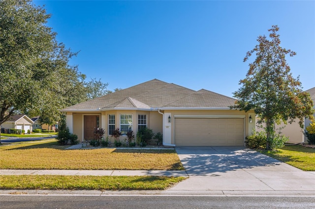 ranch-style house featuring a garage and a front lawn