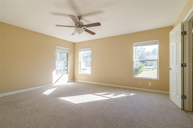 carpeted spare room with ceiling fan