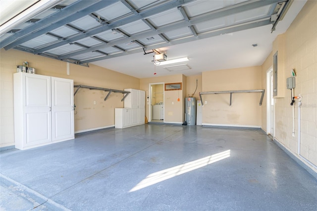 garage with electric water heater, washer / clothes dryer, and a garage door opener