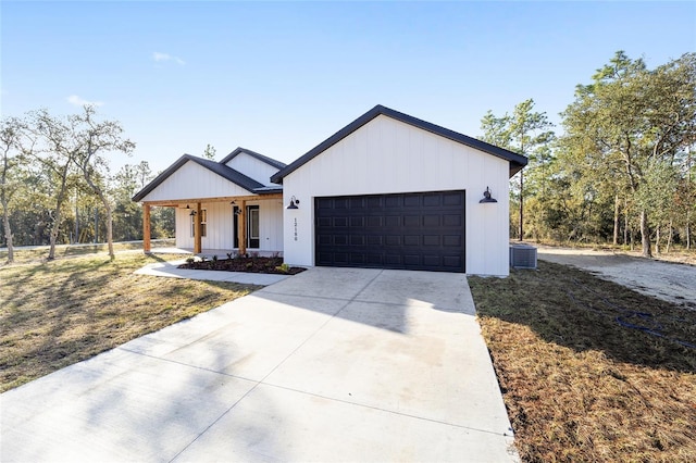 modern farmhouse style home featuring central AC, a garage, and a front yard