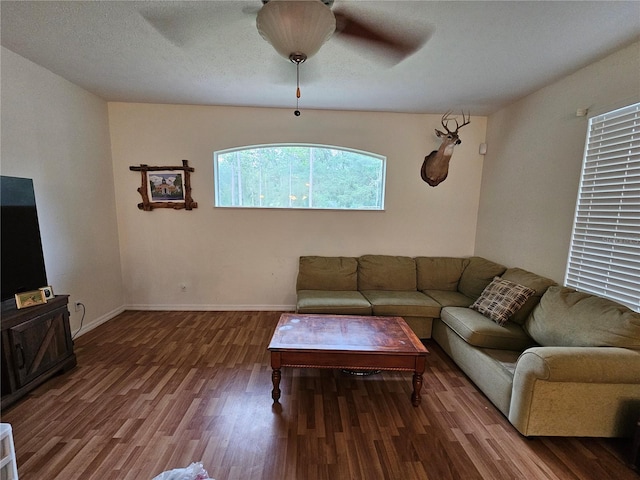 living room with a textured ceiling, hardwood / wood-style flooring, and ceiling fan