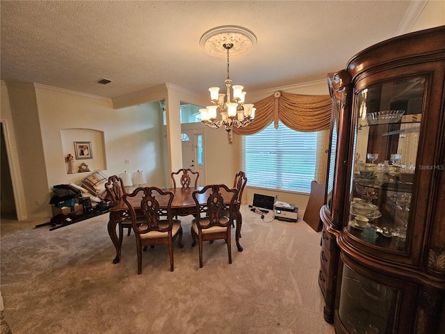 dining room with ornamental molding, carpet, a textured ceiling, and a chandelier