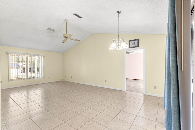 unfurnished room featuring lofted ceiling, light tile patterned floors, ceiling fan with notable chandelier, and a textured ceiling