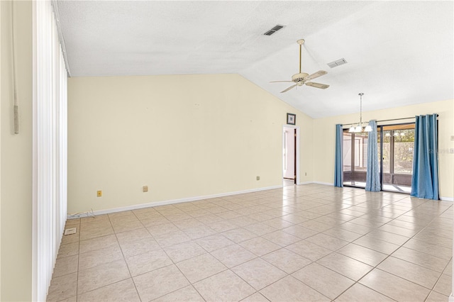 tiled spare room featuring lofted ceiling, ceiling fan with notable chandelier, and a textured ceiling