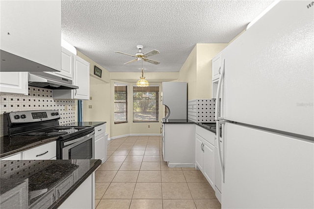 kitchen featuring white cabinetry, dark stone counters, white refrigerator, light tile patterned floors, and electric range